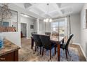 Bright dining room with coffered ceiling and a view to the kitchen at 241 Fair Oaks Ct, Mebane, NC 27302