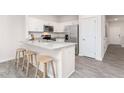 Kitchen features granite island with seating and stainless steel appliances at 30 Virgo Dr, Angier, NC 27501