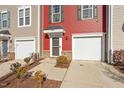 Townhome exterior featuring a red and beige facade and attached garage at 386 Cotton Brook Dr, Fuquay Varina, NC 27526