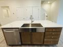Kitchen island with a stainless steel sink, dishwasher, and wooden cabinets at 494 Traditions Grande Blvd # 25, Wake Forest, NC 27587