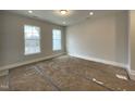 Bright bedroom with large windows offering ample natural light and serene views at 496 Traditions Grande Blvd # 24, Wake Forest, NC 27587