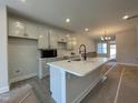 Modern kitchen features a large island with quartz countertops, stainless steel appliances, and ample cabinetry at 498 Traditions Grande Blvd # 23, Wake Forest, NC 27587