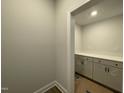 Well-lit pantry with counter space and storage cabinets, enhancing kitchen organization at 498 Traditions Grande Blvd # 23, Wake Forest, NC 27587