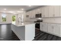 Bright, spacious kitchen features white cabinets, stainless appliances, and granite countertops at 500 Traditions Grande Blvd # 22, Wake Forest, NC 27587