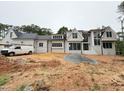 New construction home with a painted white brick exterior, black framed windows, and craftsman design at 7013 Buckhead Dr, Raleigh, NC 27615