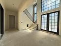 Grand foyer with staircase, large windows and double glass doors offering lots of natural light at 7013 Buckhead Dr, Raleigh, NC 27615