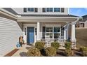 Front porch with rocking chairs and landscaping at 704 Porter Hill Dr, Youngsville, NC 27596