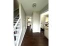 Hallway with hardwood floors leading to the kitchen and living area at 9201 Sayornis Ct, Raleigh, NC 27615
