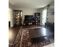 Cozy living room with dark wood floors, neutral walls, and stylish decor at 9201 Sayornis Ct, Raleigh, NC 27615