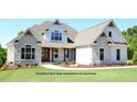 Beautiful modern farmhouse with stone accents, white siding, a gabled roof and welcoming front porch on a well-maintained lawn at 11204 Old Beulah Rd, Kenly, NC 27542