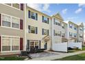 Townhome community featuring multiple three-story units with neutral siding and white fences at 2225 Raven Rd # 107, Raleigh, NC 27614