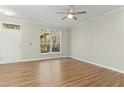 Bright living room featuring hardwood floors and a large window at 2225 Raven Rd # 107, Raleigh, NC 27614