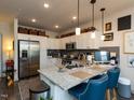 Modern kitchen features granite counters, stainless appliances, and breakfast bar seating at 2313 Gathering Square Ct # 2313, Fuquay Varina, NC 27526