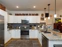 Well-equipped kitchen boasts stainless steel appliances and ample cabinet space at 2313 Gathering Square Ct # 2313, Fuquay Varina, NC 27526