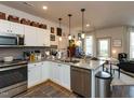 Bright, open kitchen with stainless steel appliances and access to the living area at 2313 Gathering Square Ct # 2313, Fuquay Varina, NC 27526