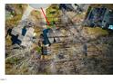 Home situated on a wooded lot with a driveway and detached structure at 3 Moss Spring Ct, Durham, NC 27712