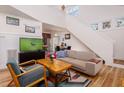 Bright living room with hardwood floors, comfy seating and a large TV at 3 Moss Spring Ct, Durham, NC 27712