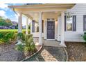 Front entrance with a gray door, columns and brick walkway at 3141 Rapid Falls Rd, Cary, NC 27519