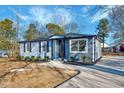 Newly renovated home with gray siding, stone accents, and landscaping at 406 Everette Ave, Clayton, NC 27520