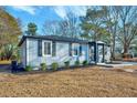 Newly renovated home with gray siding, stone accents, and landscaping at 406 Everette Ave, Clayton, NC 27520