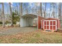 Red storage shed and metal carport in backyard setting at 4139 Somerset Dr, Oxford, NC 27565