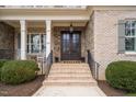 Double front doors with brick and stone accents at 416 Calderbank Way, Cary, NC 27513