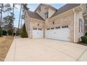 Two-car garage with white doors and a large driveway at 416 Calderbank Way, Cary, NC 27513