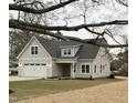 Beautiful exterior view of the gray siding and front-facing two car garage at 504 Tucker St, Four Oaks, NC 27524