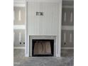 A bright fireplace with white shiplap and molding is ready to be installed at 504 Tucker St, Four Oaks, NC 27524