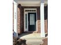 Black front door entry to townhome with sidelights and transom at 549 Balsam Fir Dr Dr, Cary, NC 27519