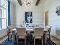 Dining room with shiplap walls, a large window, and a modern chandelier at 64 W Beech Slope Ct, Chapel Hill, NC 27517