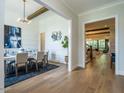 Formal dining room with a statement light fixture and hardwood floors at 64 W Beech Slope Ct, Chapel Hill, NC 27517