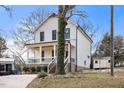 Two-story craftsman home with white siding, black windows, and a front porch at 649 Mcadams Rd, Hillsborough, NC 27278