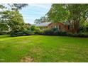 Brick ranch house with a large green lawn at 715 Powell Dr, Raleigh, NC 27606