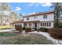 Two-story house with white exterior, brown roof, and landscaping at 7300 Grist Mill Rd, Raleigh, NC 27615