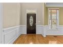 Welcoming entryway with hardwood floors, decorative moldings, and a front door with glass inlays at 8005 Sundance Cir, Durham, NC 27713