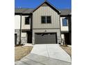 Two-story townhome with stone and board and batten accents and a two-car garage at 962 Double Helix Rd, Apex, NC 27523