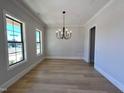 Light filled dining room with modern chandelier and hardwood floors at 1031 Coldspring Circle, Durham, NC 27705
