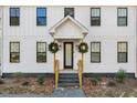 Front entrance with wooden stairs and two wreaths at 113 Laurston Ct, Durham, NC 27712