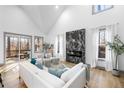 Living room with hardwood floors, fireplace, and access to deck at 113 Laurston Ct, Durham, NC 27712