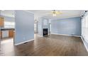 Spacious living room with hardwood floors, fireplace, and plenty of natural light at 133 John Winstead Rd, Louisburg, NC 27549