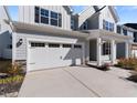 Attached two-car garage with white doors and black accents, complementing the home's exterior at 137 Alderbranch Cir, Garner, NC 27529