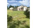 Tan house with red door and attached garage, on a grassy lot at 159 Bywood Dr, Roxboro, NC 27573
