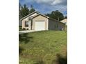 Tan house with white garage door and large grassy yard at 159 Bywood Dr, Roxboro, NC 27573
