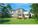 A luxurious backyard featuring a wooden deck, a manicured lawn, and lush landscaping at 180 Bur Oak Ct, Pittsboro, NC 27312
