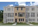 Attractive new construction townhome with a brick exterior and a private balcony at 203 Broomgrove Way, Wake Forest, NC 27587