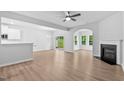Open concept living room with fireplace and access to backyard and adjacent kitchen area at 2094 Harris Farm Ct, Burlington, NC 27215