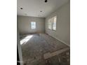 Bright bedroom with natural light from multiple windows, ready for new flooring and your personal touch at 210 N Driver St, Durham, NC 27703