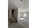 Spacious living room under renovation, with a stairway, offering a blank canvas for your dream interior design at 210 N Driver St, Durham, NC 27703