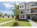New construction townhouse with lawn and young landscaping; inviting facade with black-framed windows at 2117 Treelight Way, Wendell, NC 27591